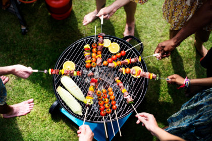 Aerial View Of A Diverse Group Of Friends Grilling Barbecue Outdoors